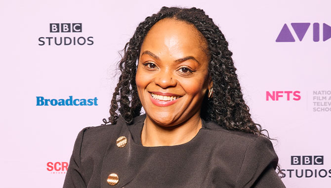 Young woman smiling, standing in front a background with logos