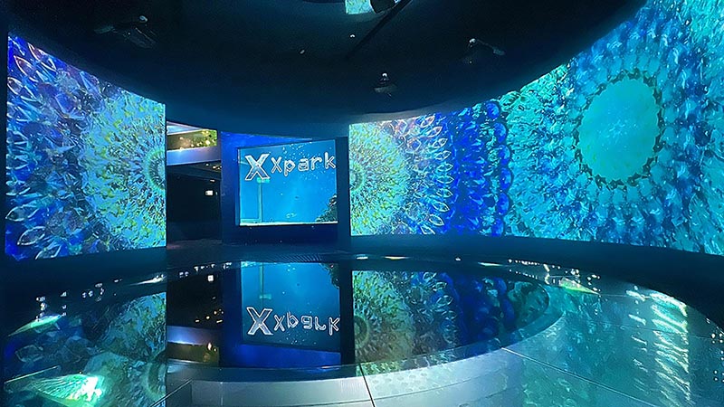 Vivid projections on several massive curved screens at Xpark's 