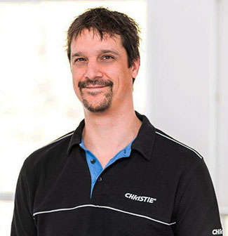 Headshot of a man with dark hair wearing a golf shirt.