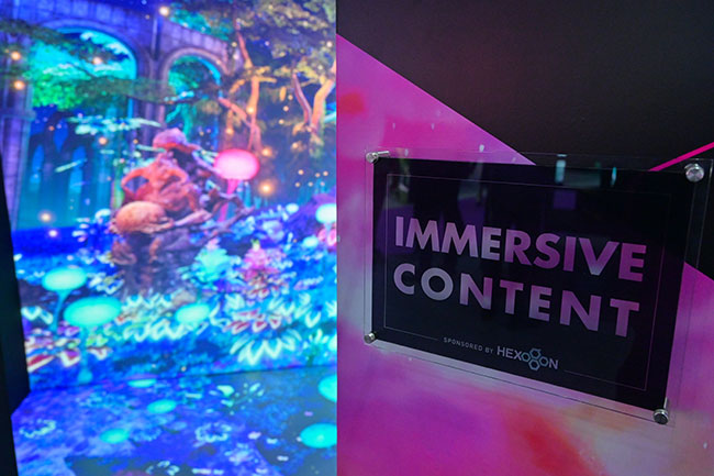 A sign outside of an immersive room reads, &ldquo;Immersive content sponsored by Hexogon&rdquo;