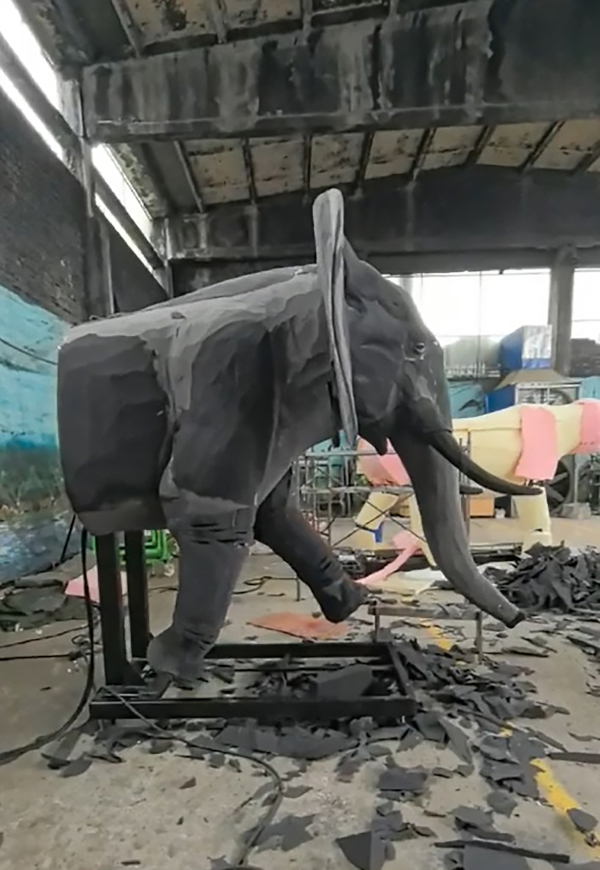 An animatronic elephant being covered in grey silicone &ldquo;skin&rdquo;.