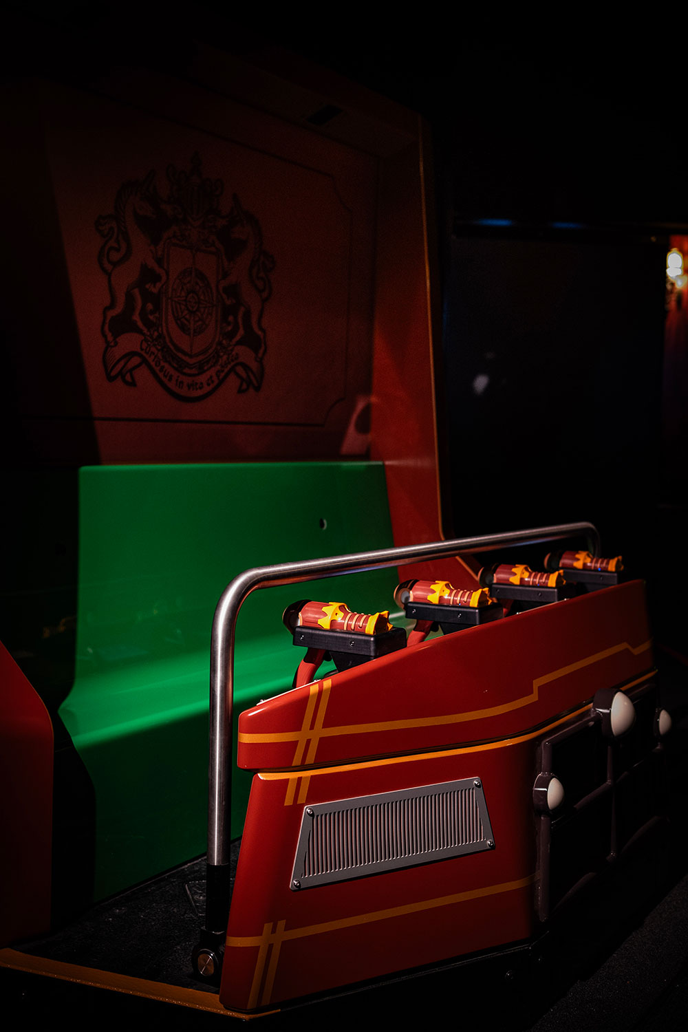 A red ride vehicle with a green seat.