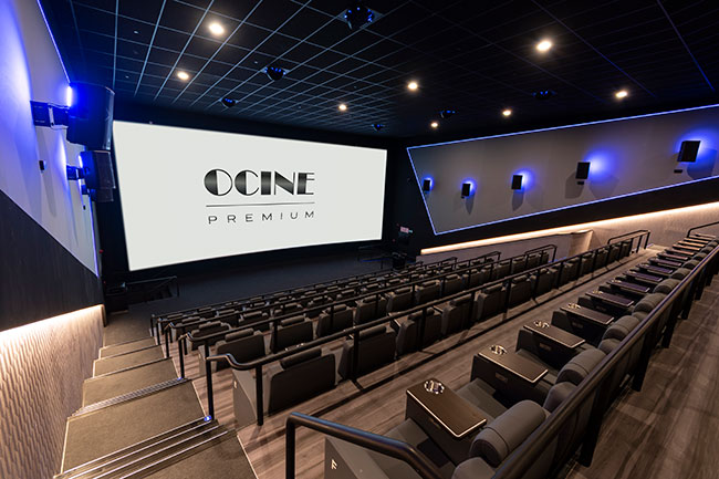 An empty movie theatre with the text &ldquo;Ocine Premium&rdquo; projected onto the screen.