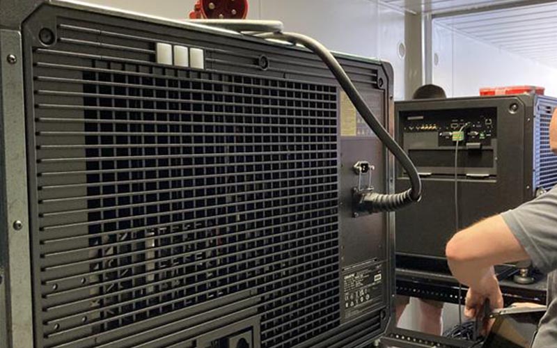 Christie technicians setting up a cinema projector