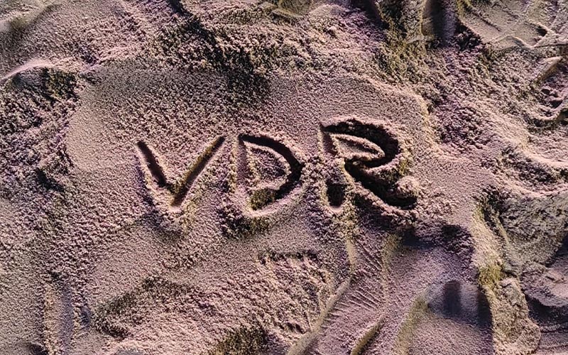 The acronym 'VDR' written in sand