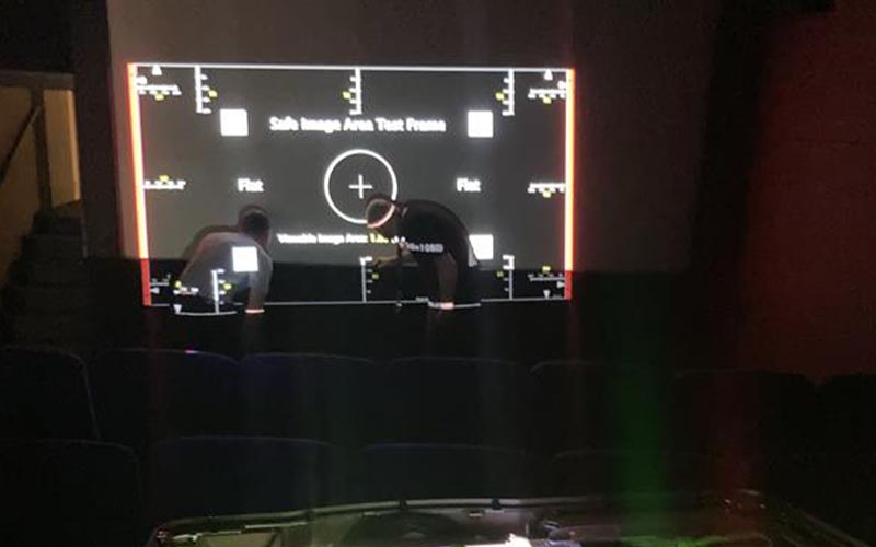 Christie technicians setting up a cinema projector