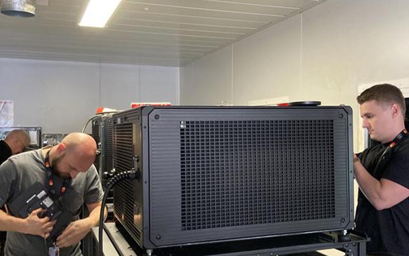 Christie technicians setting up a cinema projector