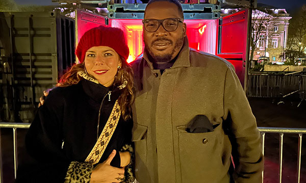 Man and woman stand in front of Christie projectors.