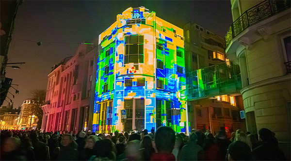 A pattern of yellow, green and blue projected onto the Cr&eacute;dit Mutuel Nord Europe building 